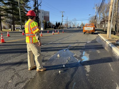 Water leak repair underway in the roadway.