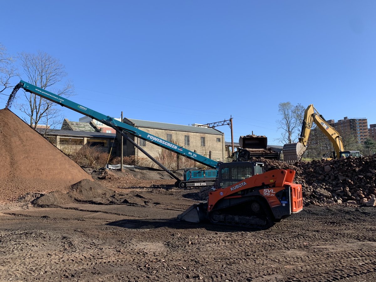 Screening conveyor with a Takeuchi loader feeding material at 110 Washington.